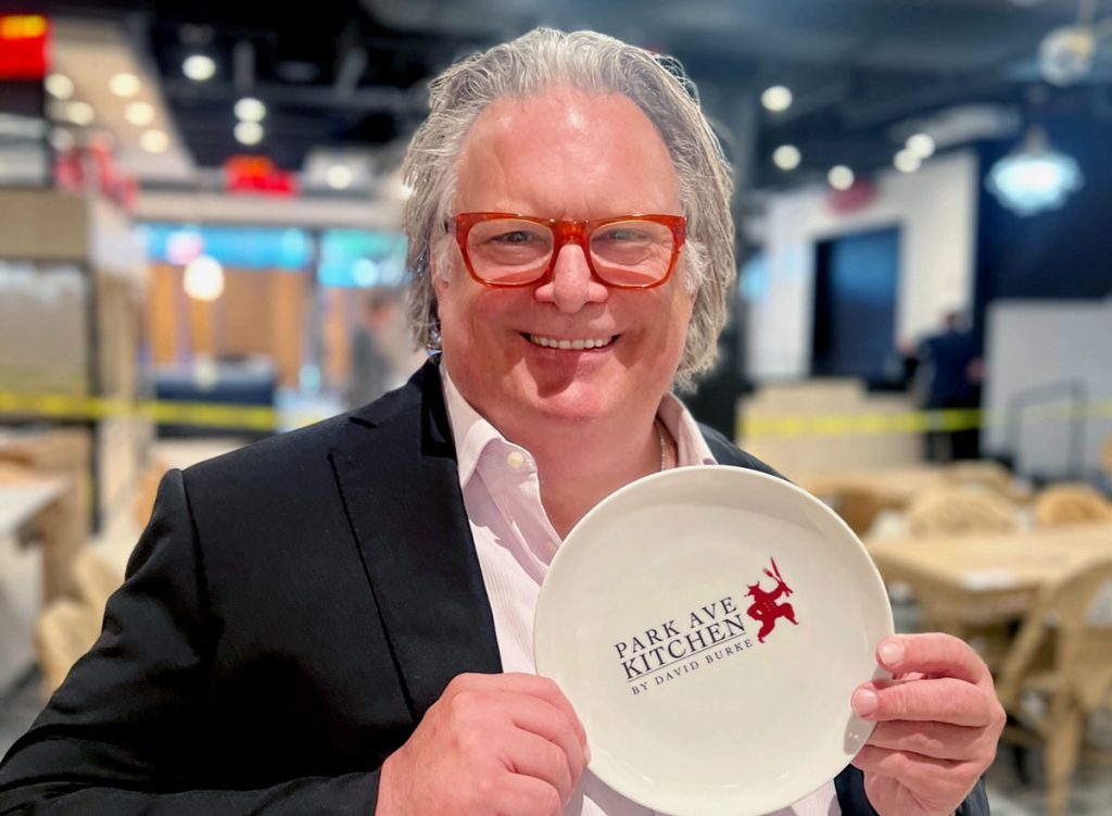 Chef David Burke holding a Park Ave Kitchen logoed plate